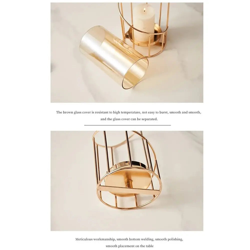 A gold-toned metal and glass candle holder with a removable top, displayed on a light surface.