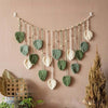 Bohemian macrame leaf wall hanging featuring various sized green and cream leaves with tassels.