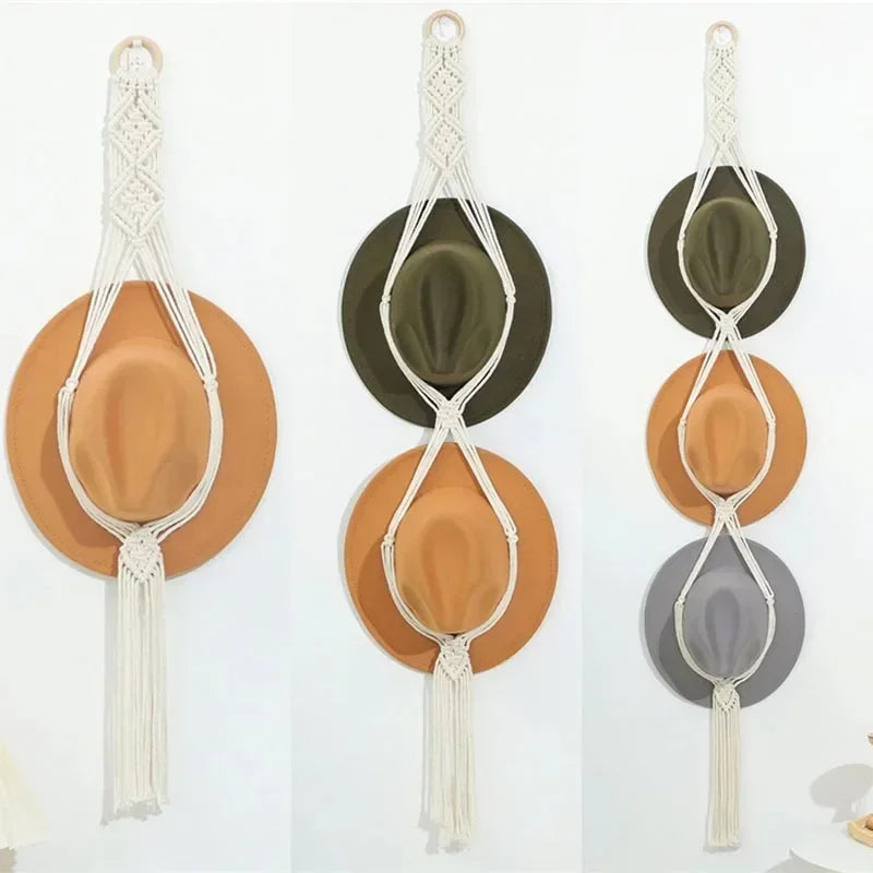 Handmade macrame hat organizer with a wooden dowel featuring beige and olive green tones.