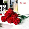 A bouquet of red rose building blocks displayed on a white surface.