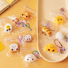 Clear plastic pouches filled with cute cartoon food squeeze toys and keychains