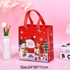 A red non-woven gift tote bag with a festive Christmas print featuring Santa, reindeer, and a Christmas tree.