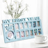 A wooden photo frame display showing monthly growth photos for a baby's first year