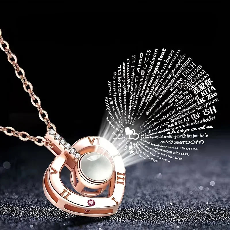 Gros plan d'un ensemble collier et pendentif en or rose avec du texte projeté sur une surface sombre.