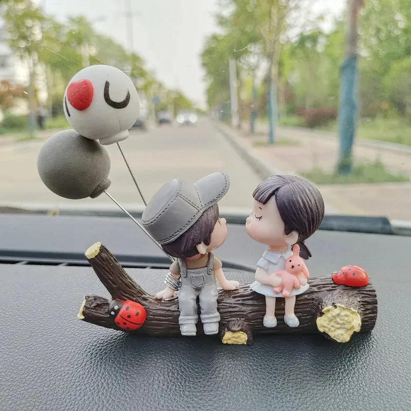 A set of cute couple balloon car ornaments featuring a girl and a boy with a pink rabbit on a wooden branch.
