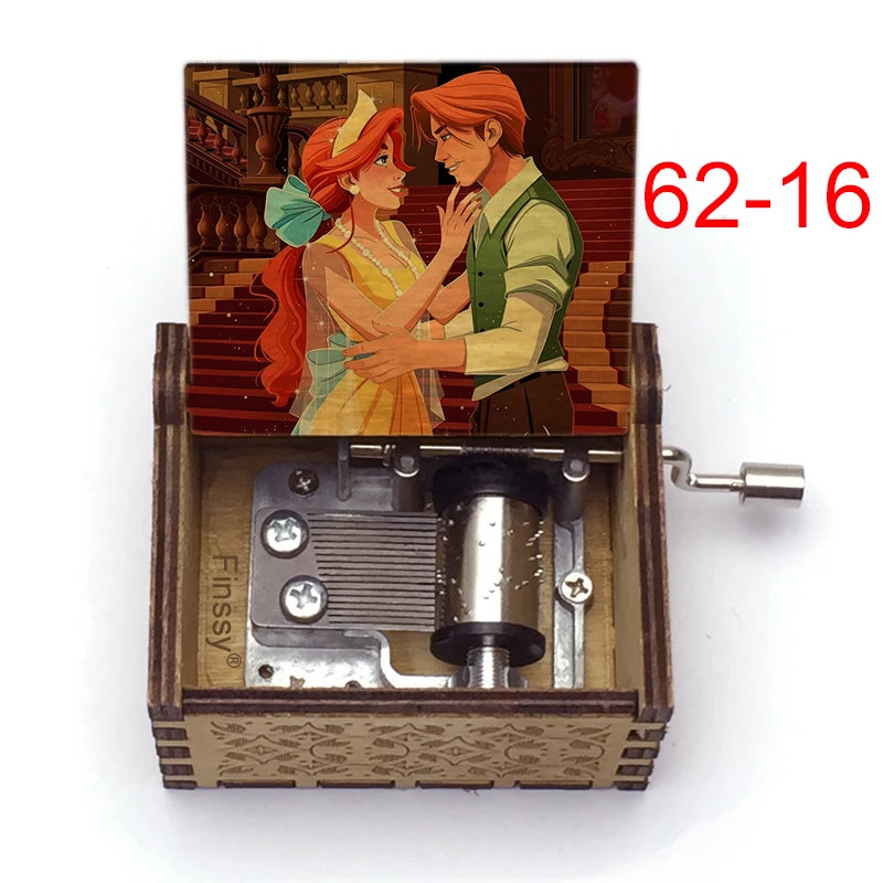 A hand-cranked wooden music box featuring an illustration of two characters, one with red hair and the other with orange hair