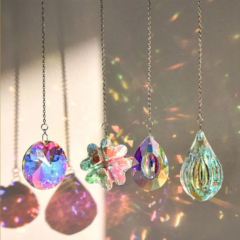 Five hanging crystal wind chimes or suncatchers of various iridescent colors and shapes