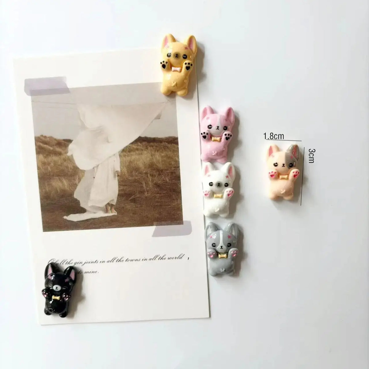 A set of mini puppy refrigerator magnets in various pastel colors and sizes.