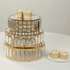 A set of three clear crystal and gold metal tiered cake stands displaying cupcakes.