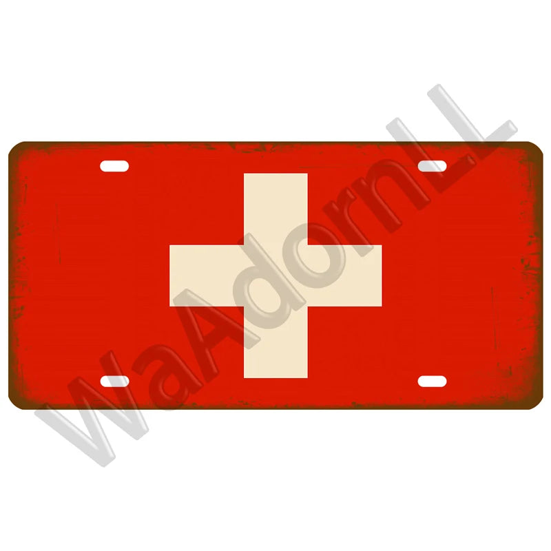 A vintage red metal tin sign featuring a white Swiss cross symbol.
