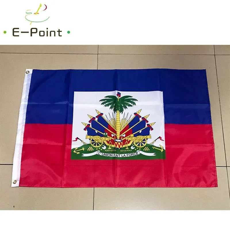 A fabric display of the Haitian national flag featuring blue, red, and white with a green palm tree and motto.
