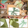 A collection of light green satin silk ribbons tied in bows and decorative elements on a rustic wooden background.