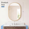 Oval wall mirror with a gold metal frame hanging above a marble vanity countertop.