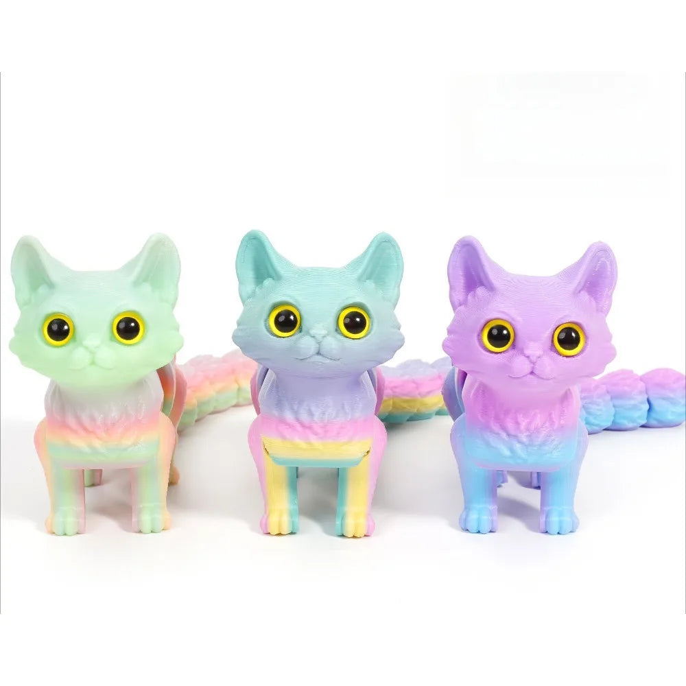 Three 3D printed cat figurines in pastel colors with articulated tails.