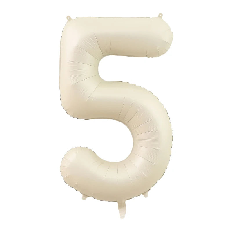 A beige foil number balloon shaped like the numeral five.