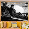 A black and white manga art tapestry featuring a dramatic figure in a cloak against a bright background.