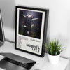 A framed canvas wall art featuring a dark, dramatic image of an angel with wings and a halo.