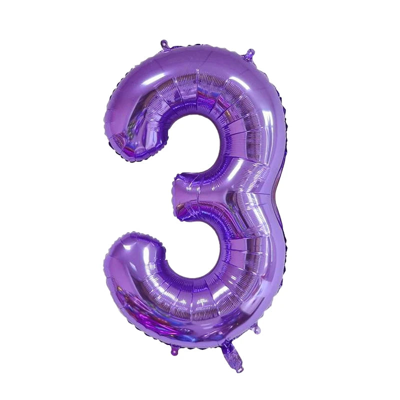 A purple foil number balloon shaped like the number three.