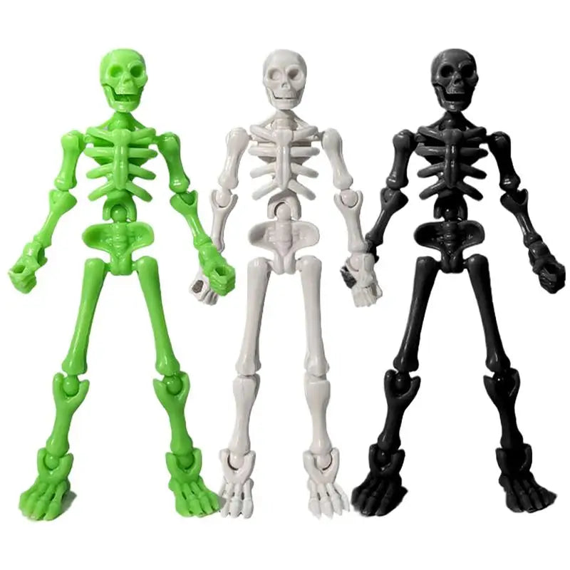 Three plastic skeleton figurines in green, white, and black for craft and decor
