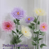 Artificial silk flower arrangement featuring purple and yellow poppy heads on green stems and bases.