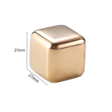 A square, polished gold-toned stainless steel ice cube with dimensions of 27mm on each side.