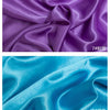 Close-up of purple and teal satin fabric folds showing texture and sheen for sewing projects