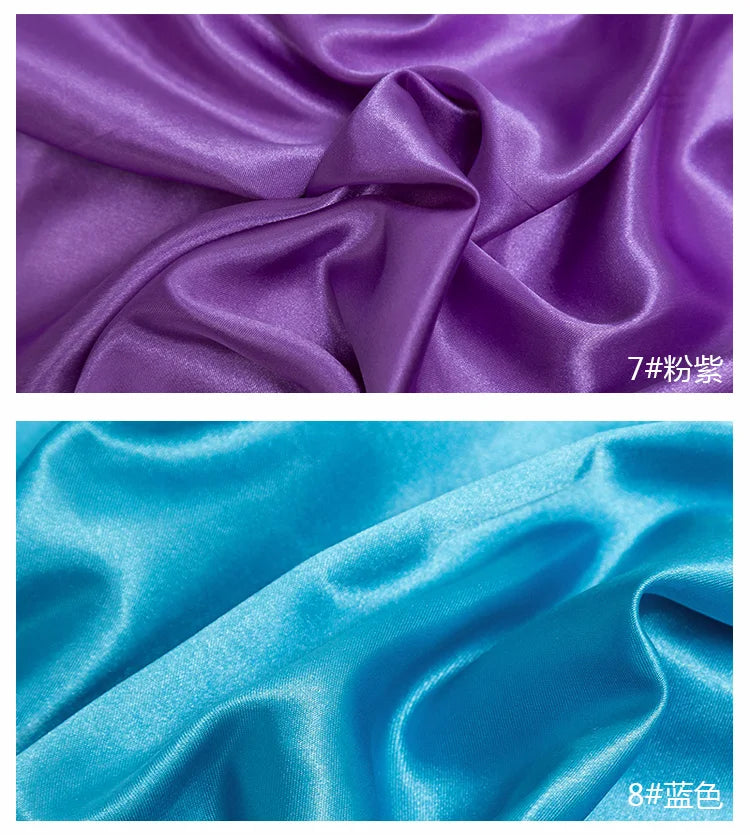 Close-up of purple and teal satin fabric folds showing texture and sheen for sewing projects