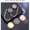 A set of metal creative hooks of various sizes and finishes displayed on a dark surface.