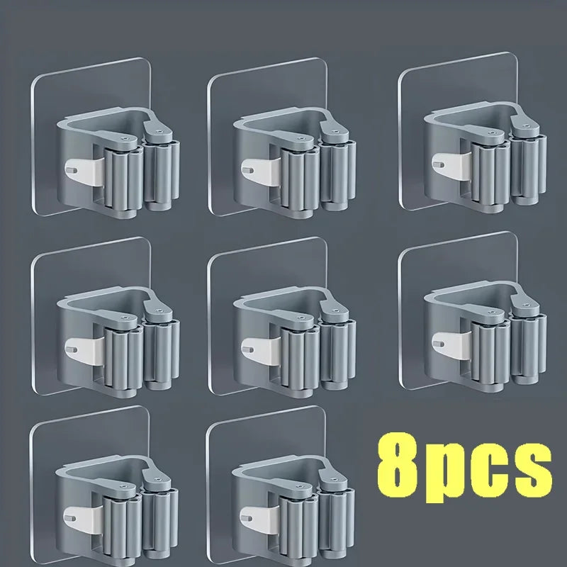 Eight wall mounted holders for storing mops and brooms in a silver finish