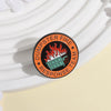 An enamel pin featuring a stylized fire truck on a black background with the text Dumpster Fire Response Team