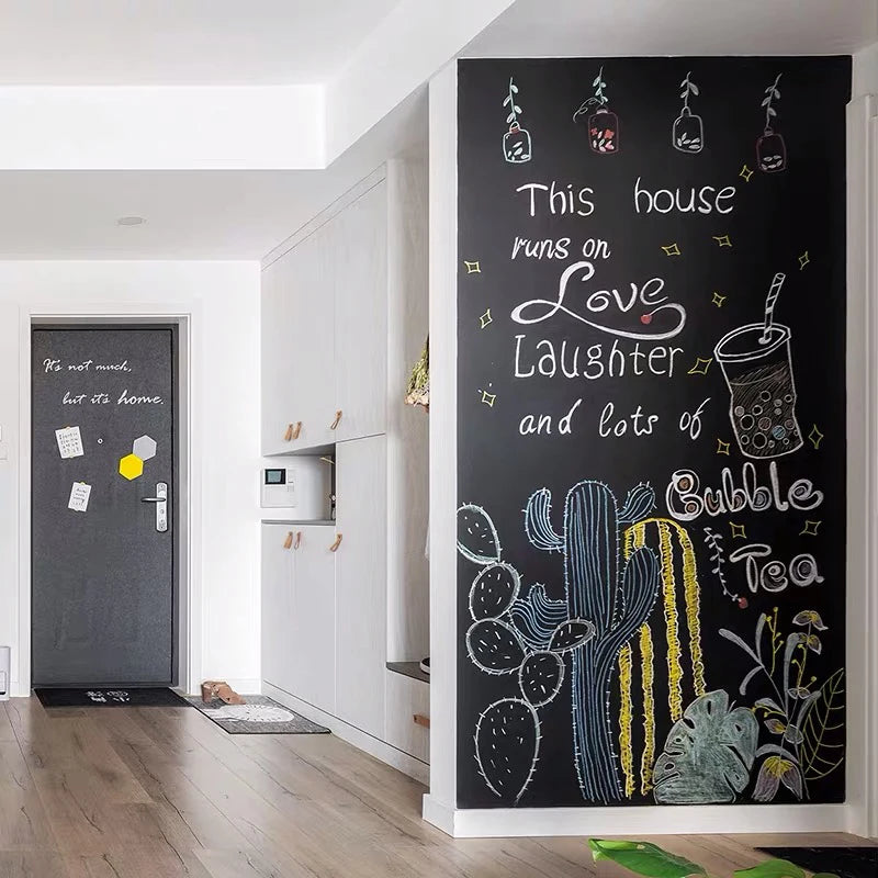 A dark chalkboard wall sticker featuring hand-drawn illustrations of cacti and text about love, laughter, and bubble tea.