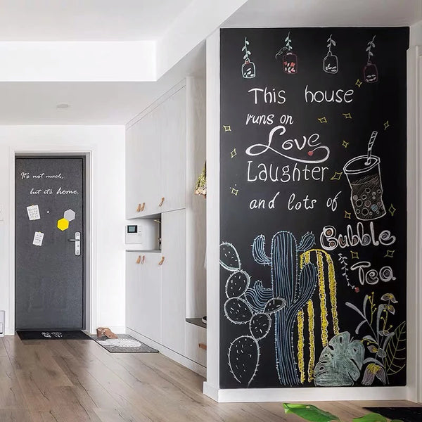 A dark chalkboard wall sticker featuring hand-drawn illustrations of cacti and text about love, laughter, and bubble tea.