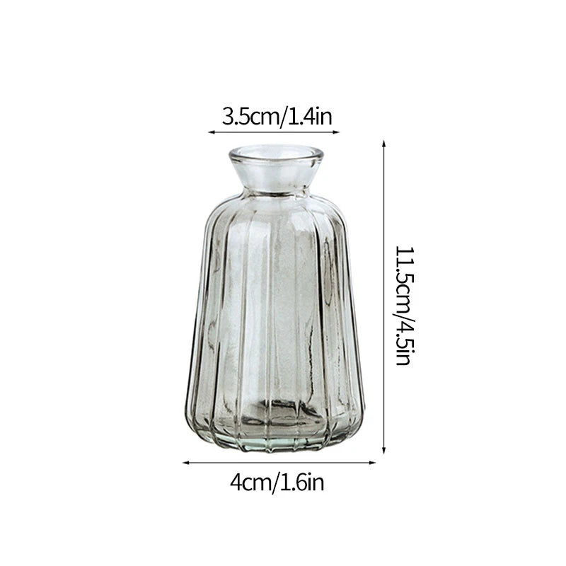 A clear glass vase with a rounded neck and tapered body, measuring 3.5cm wide and 11.5cm tall.