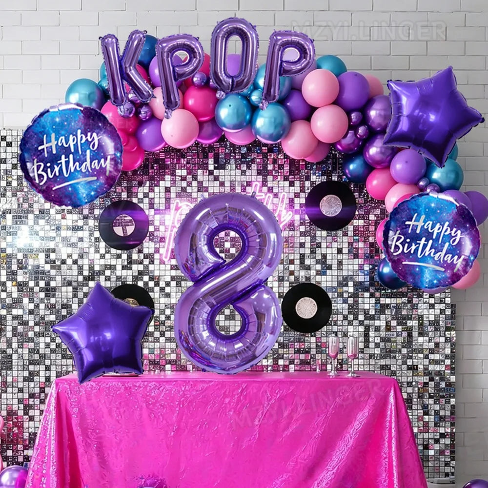 A colorful balloon arch featuring purple and pink foil numbers spelling 'KPOP' and a large number 8 for a birthday celebratio