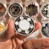 A hand holds a commemorative coin featuring the phrase Full on the Sword of God with various religious symbols.