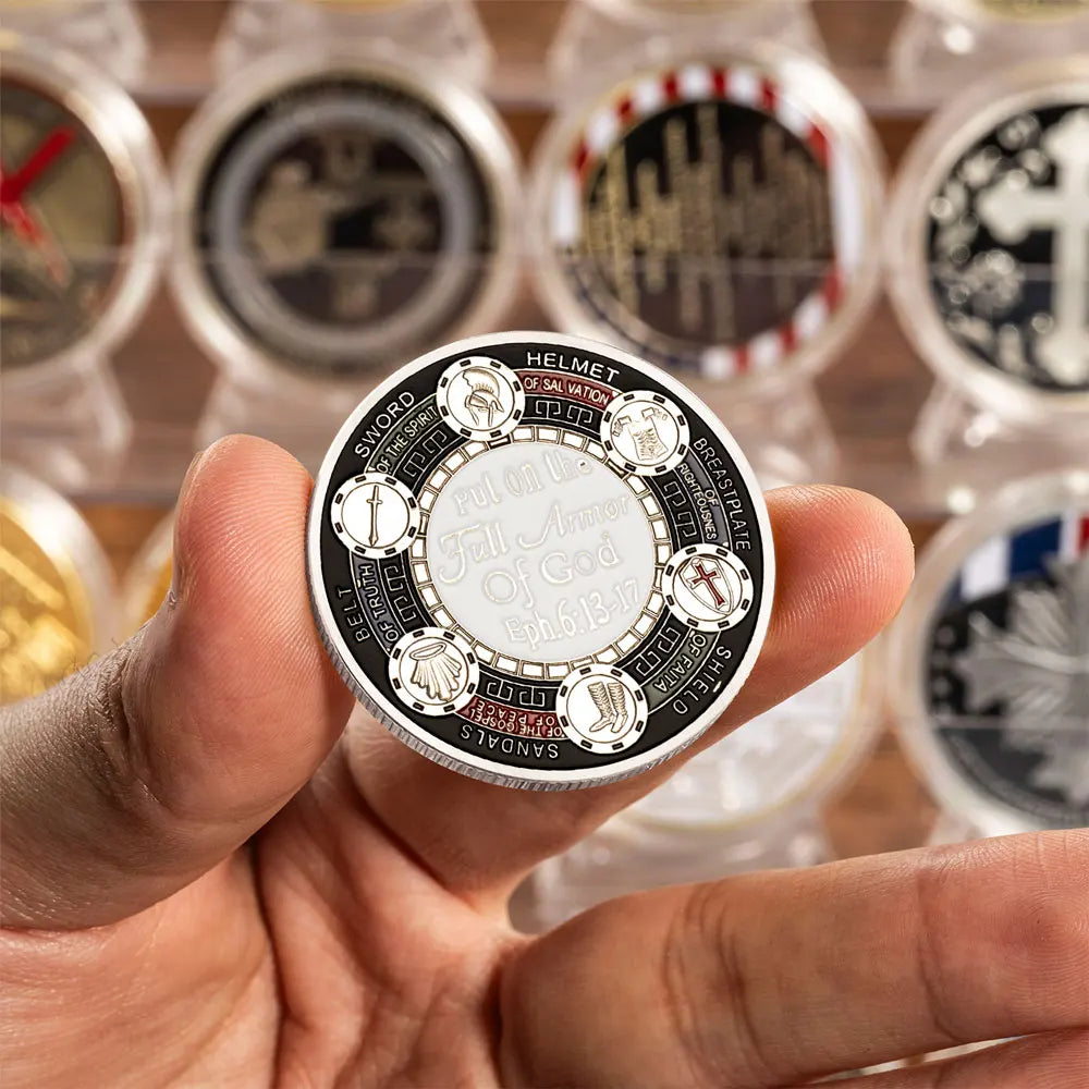 A hand holds a commemorative coin featuring the phrase Full on the Sword of God with various religious symbols.