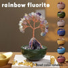 Rainbow fluorite crystal tree in a green bowl with various colored crystals and gold coins