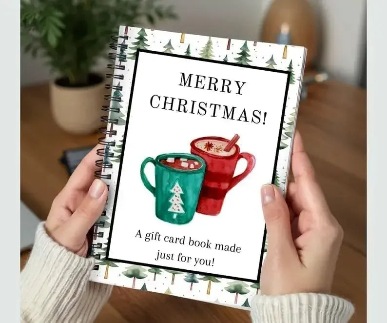 A handmade Christmas card book with a green mug design and festive greenery on the cover.