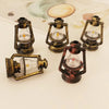 A collection of vintage ceramic miniature lanterns for dollhouse décor, featuring brass and dark colored metalwork.