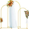 A gold metal arched wedding backdrop stand set featuring a sheer white fabric drape and floral arrangements.