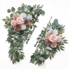 A floral kit featuring dusty rose and white roses and various eucalyptus greenery for a wedding arch.