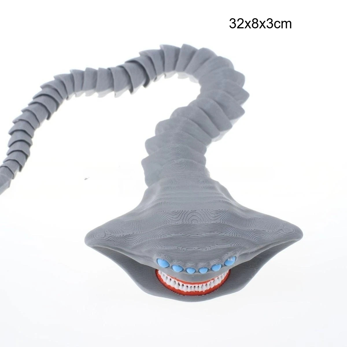 A gray, flexible sea monster fidget toy with a serpentine body and an open mouth showing teeth.