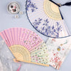 A collection of vintage silk folding hand fans in various floral and pastel patterns, including blue, pink, and white.