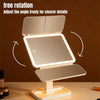 A triple fold LED makeup mirror with adjustable angle shown on a wooden surface.