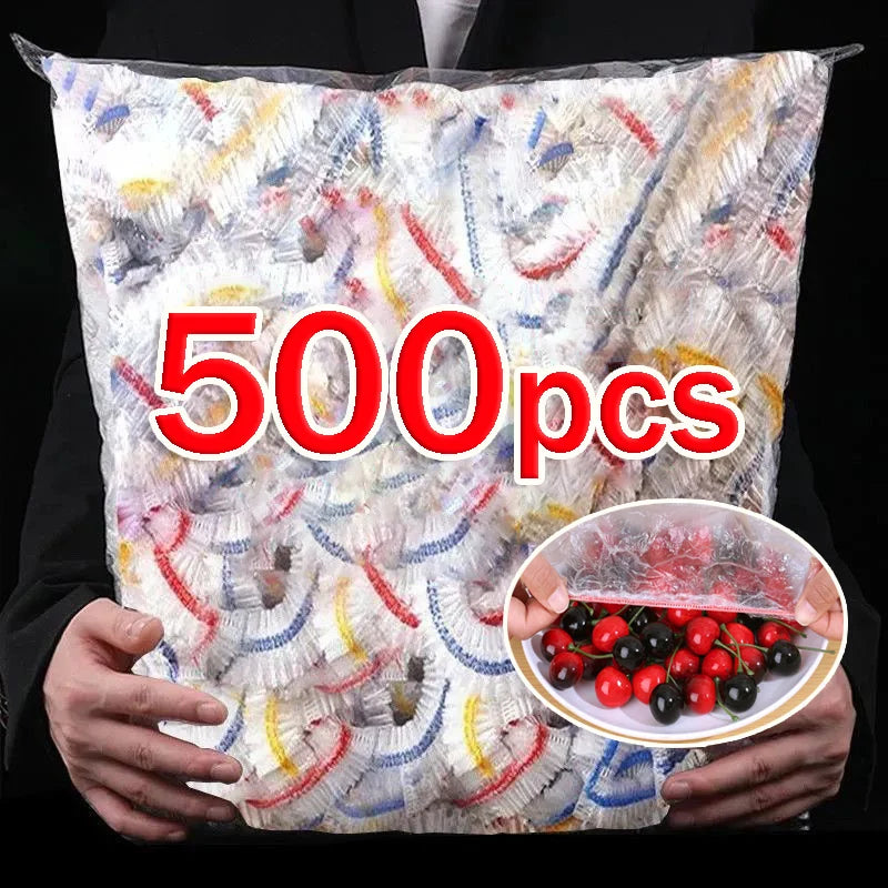 A bag of 500 disposable elastic bowl covers with food wrap in multicolor, held by a person.