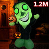 A green inflatable monster decoration with glowing eyes and a carved pumpkin, displayed in a dark setting.