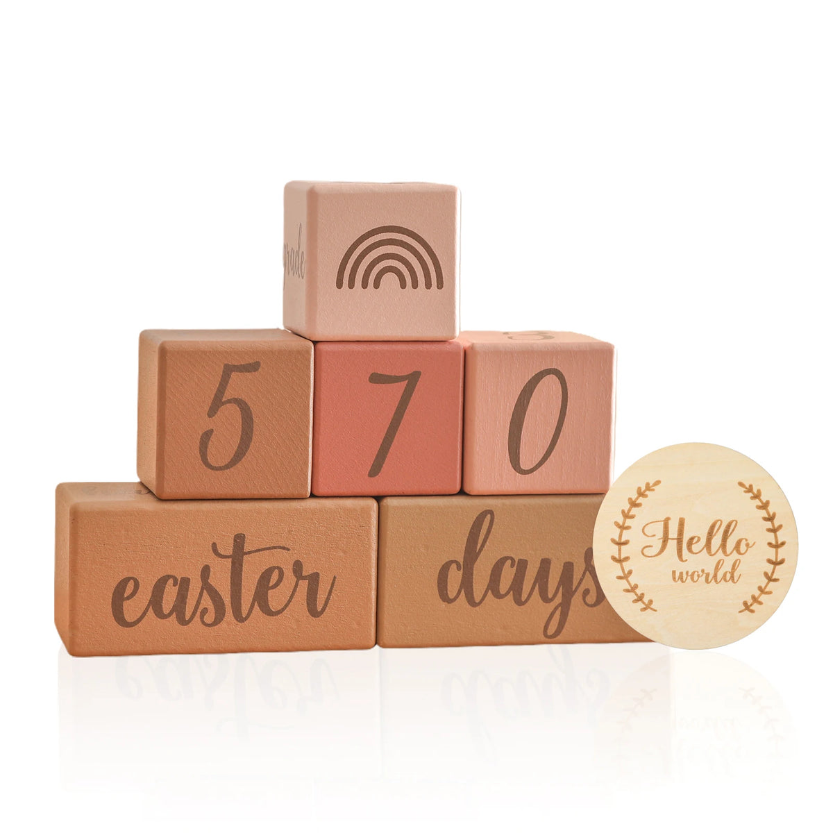 A stack of wooden baby milestone cards showing numbers 5, 7, and 0 with the word easter days on the bottom card.