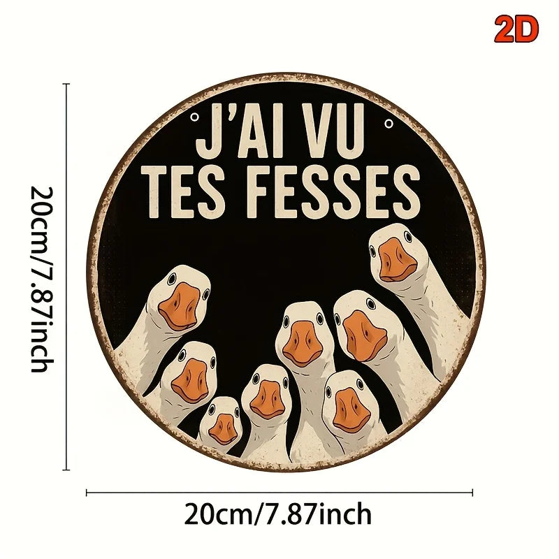 A circular wooden sign featuring multiple painted ducks with the text J'ai vu tes fesses