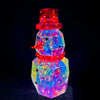 A brightly lit prismatic LED snowman decoration with glowing red and blue lights.