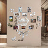 A wall featuring a decorative photo tree design with framed family pictures on a beige wall.